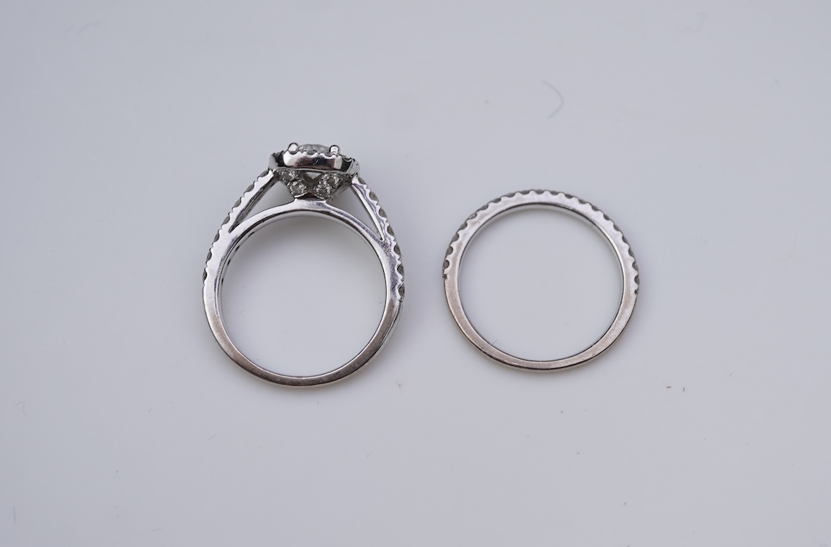 A diamond engagement ring and half eternity ring